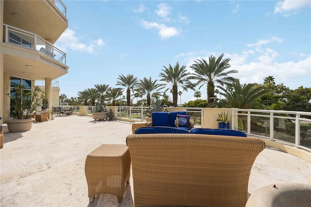 view of patio featuring a balcony, outdoor dining area, and outdoor lounge area