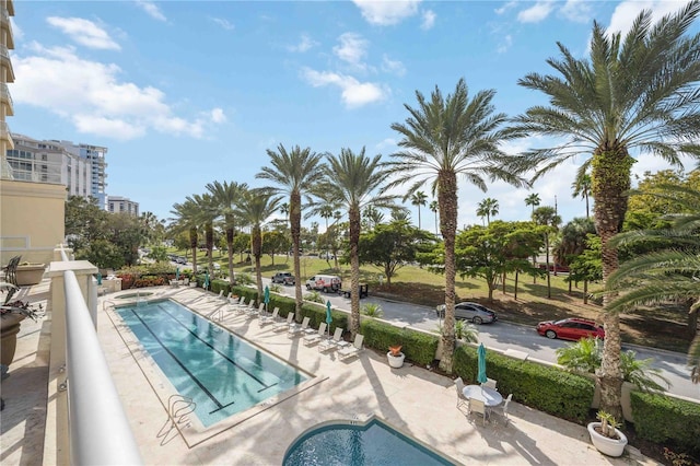 view of swimming pool with a community hot tub