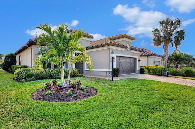 mediterranean / spanish home with a front yard and a garage