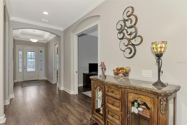 foyer entrance featuring crown molding and dark wood-type flooring