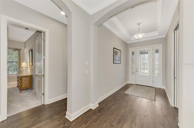 foyer entrance with dark hardwood / wood-style floors and crown molding