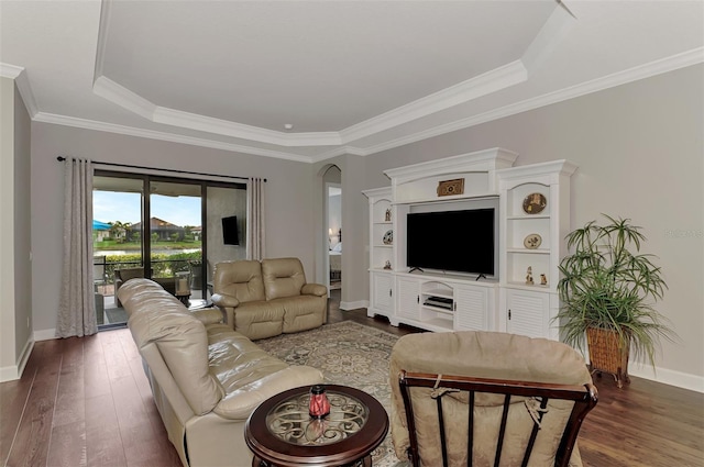 living room featuring dark hardwood / wood-style floors, a raised ceiling, and crown molding