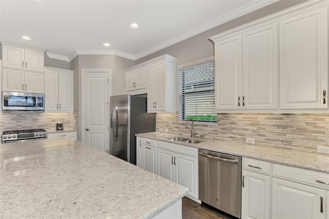 kitchen with stainless steel appliances, white cabinetry, and sink