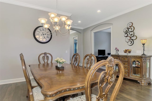 dining area with dark hardwood / wood-style flooring, a chandelier, and ornamental molding