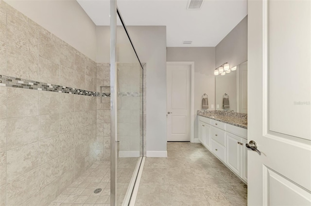 bathroom featuring vanity and a shower with shower door