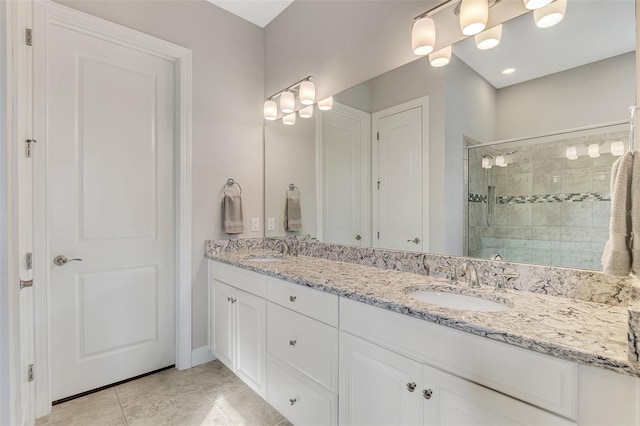 bathroom with vanity, tile patterned floors, and a shower with shower door