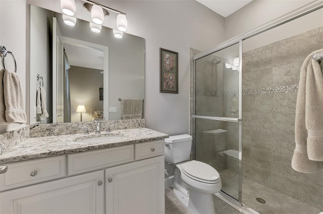 bathroom with vanity, toilet, and walk in shower