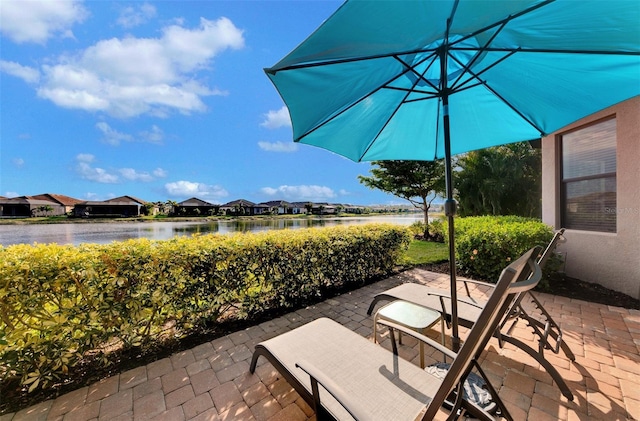 view of patio with a water view