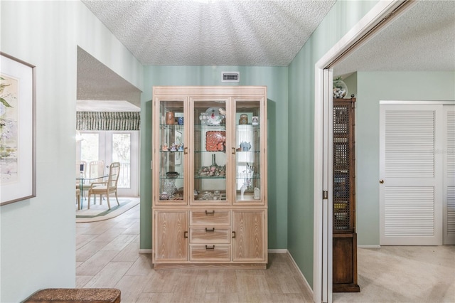 interior space with a textured ceiling