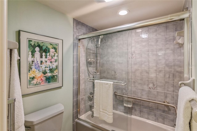 bathroom featuring shower / bath combination with glass door and toilet