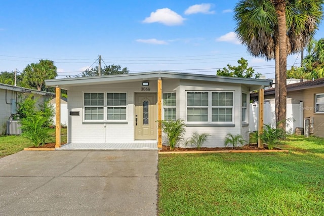 ranch-style house with a front lawn and cooling unit