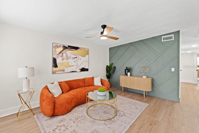 living room featuring hardwood / wood-style floors and ceiling fan