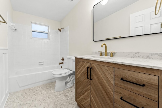 full bathroom featuring vanity, toilet, and tiled shower / bath combo