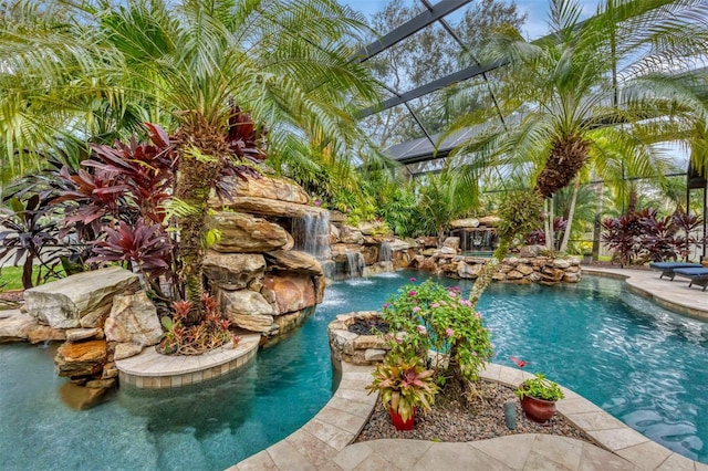 view of swimming pool featuring glass enclosure and pool water feature