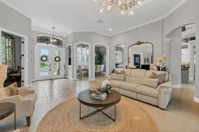 living room with a chandelier, french doors, light tile patterned floors, and crown molding