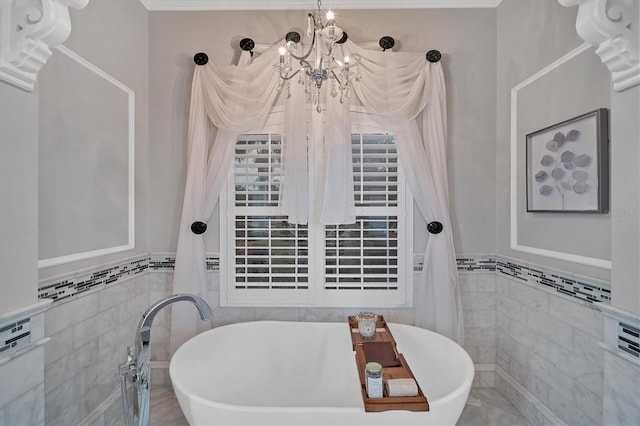 bathroom with a bathing tub, a notable chandelier, and tile walls