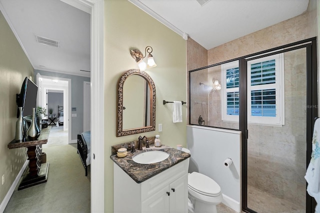 bathroom with toilet, a shower with door, vanity, and ornamental molding