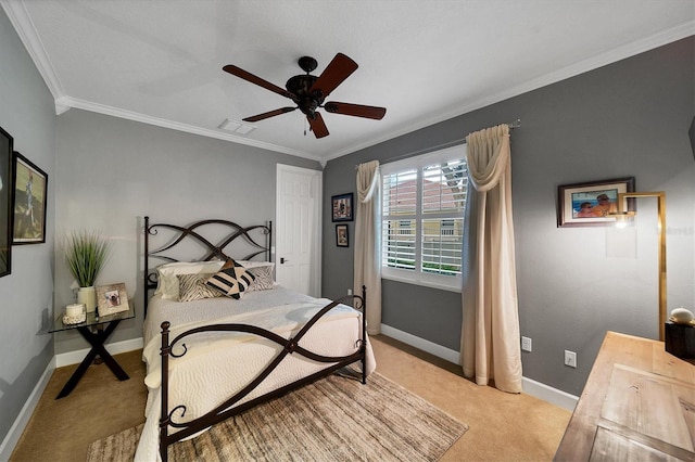 carpeted bedroom featuring ceiling fan and crown molding