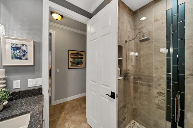 bathroom featuring tiled shower, vanity, tile patterned floors, and crown molding