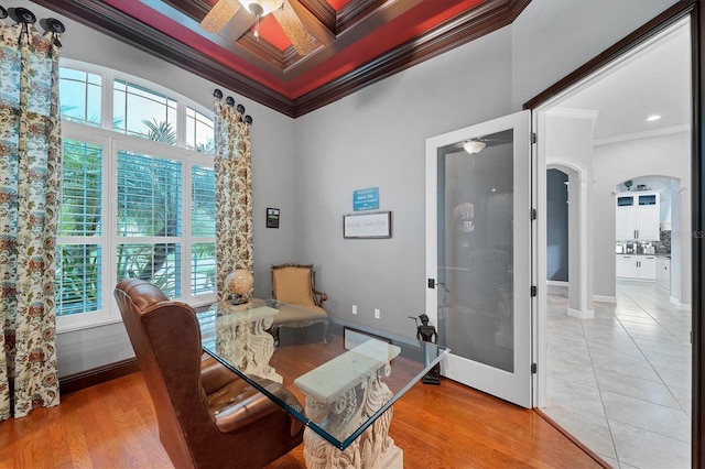 office with coffered ceiling, light wood-type flooring, ornamental molding, ornate columns, and beamed ceiling