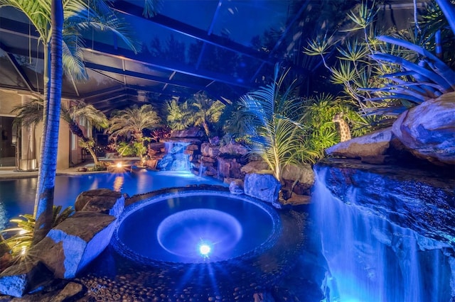 view of swimming pool with an in ground hot tub