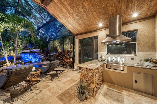 view of patio with a lanai, grilling area, sink, and exterior kitchen