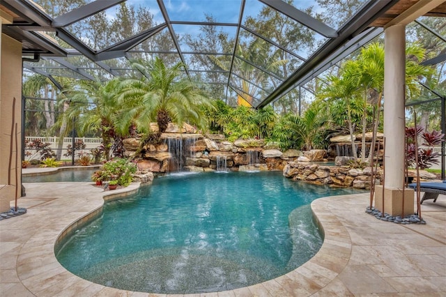 pool featuring glass enclosure and a patio area