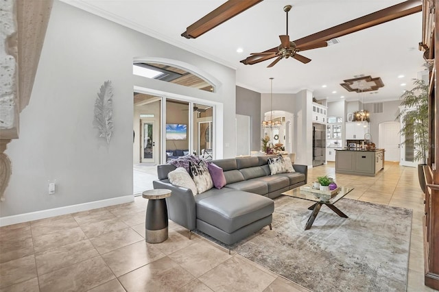 living area with crown molding, light tile patterned floors, visible vents, baseboards, and ceiling fan with notable chandelier