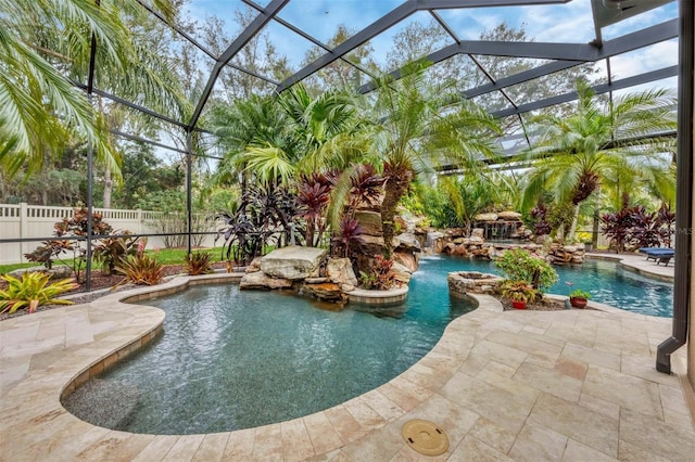 view of pool featuring glass enclosure, a patio, fence, and a fenced in pool