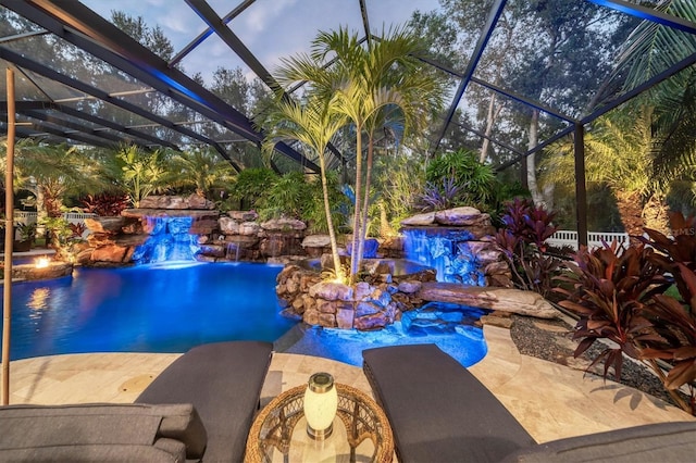 pool with glass enclosure and a patio area