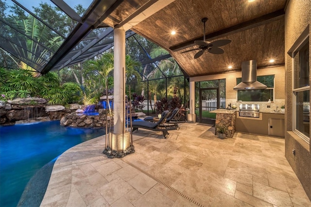 view of patio featuring a fenced in pool, area for grilling, an outdoor kitchen, ceiling fan, and a lanai