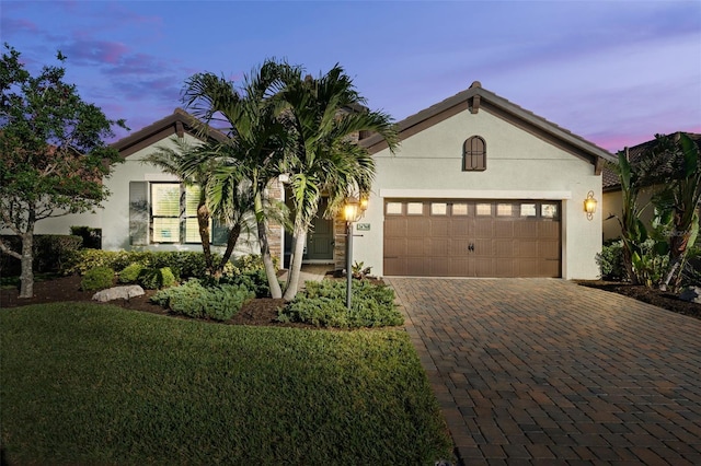 view of front of house with a lawn and a garage