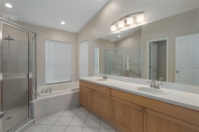 bathroom with tile patterned floors, vanity, independent shower and bath, and lofted ceiling