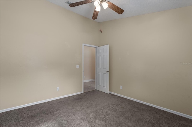 carpeted spare room featuring ceiling fan