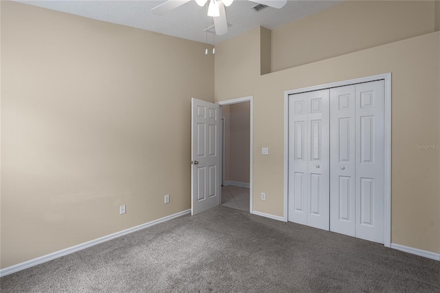 unfurnished bedroom with carpet flooring, ceiling fan, and a closet