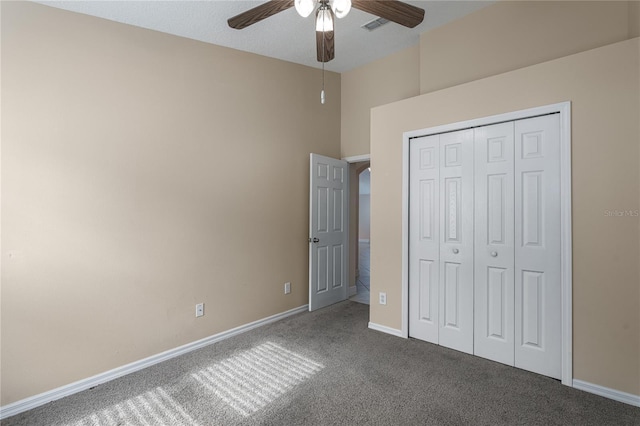 unfurnished bedroom featuring carpet, ceiling fan, and a closet