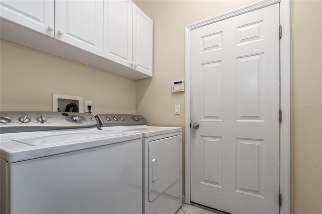 laundry area with washer and dryer and cabinets