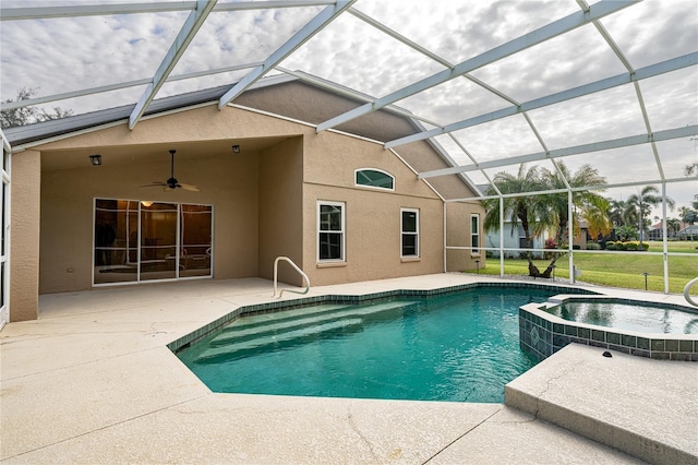 view of swimming pool with ceiling fan, a patio area, an in ground hot tub, and glass enclosure