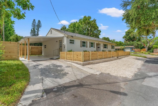 ranch-style home featuring a carport