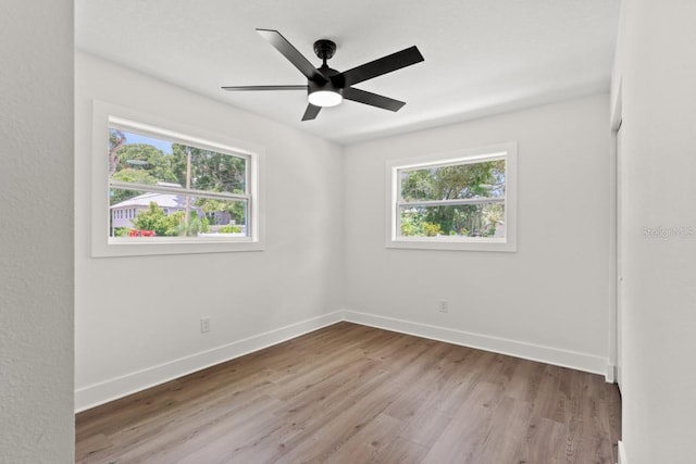 unfurnished room with a healthy amount of sunlight, ceiling fan, and light hardwood / wood-style flooring