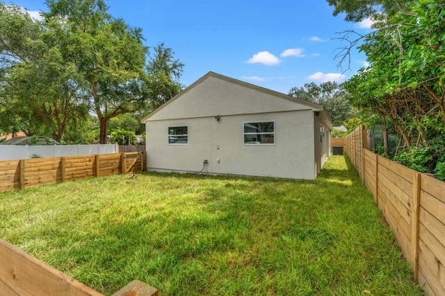 rear view of property featuring a yard