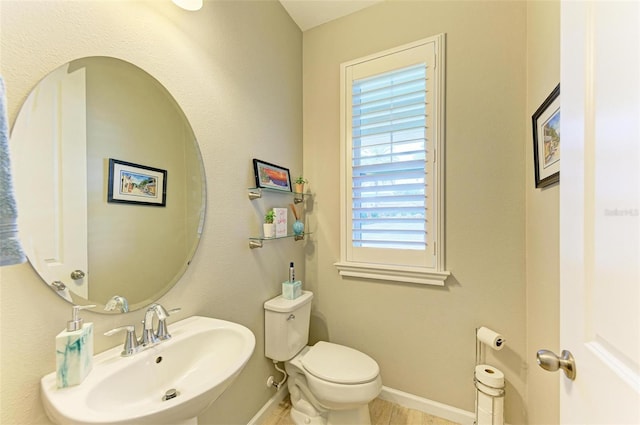 bathroom featuring toilet and sink