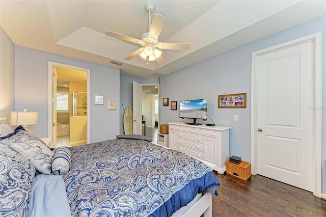 bedroom featuring ensuite bath, dark hardwood / wood-style floors, and ceiling fan