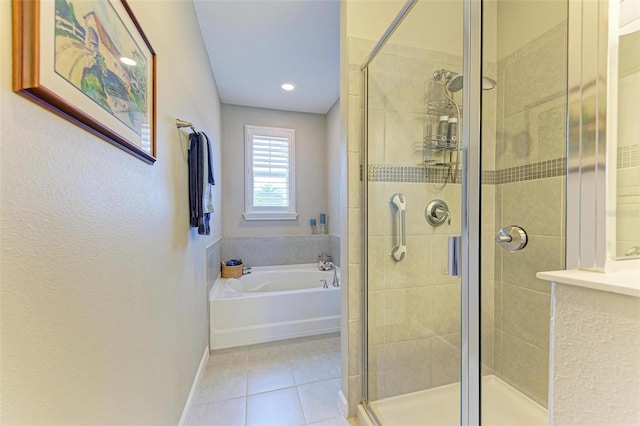 bathroom with separate shower and tub and tile patterned floors