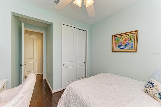 bedroom featuring ceiling fan, dark hardwood / wood-style flooring, and a closet