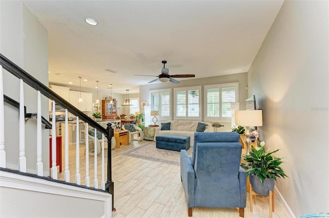 living room featuring ceiling fan and light wood-type flooring