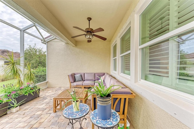 sunroom featuring ceiling fan