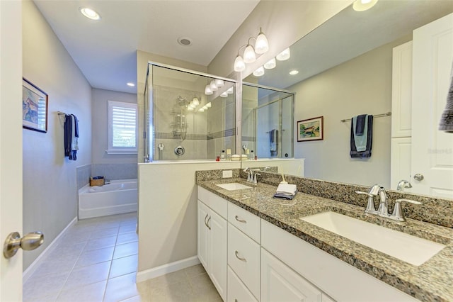 bathroom with tile patterned flooring, shower with separate bathtub, and vanity