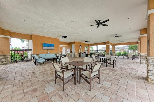 view of patio with outdoor lounge area and ceiling fan