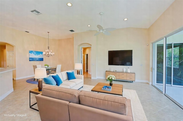 living room with ceiling fan with notable chandelier and light tile patterned floors